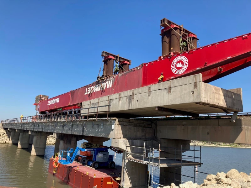 Photo is taken during the removal of the existing 166.3 Bridge over lake Eldorado.  Project was all conducted along a causeway in the middle of the lake on a work surface 28 feet wide at its widest point.