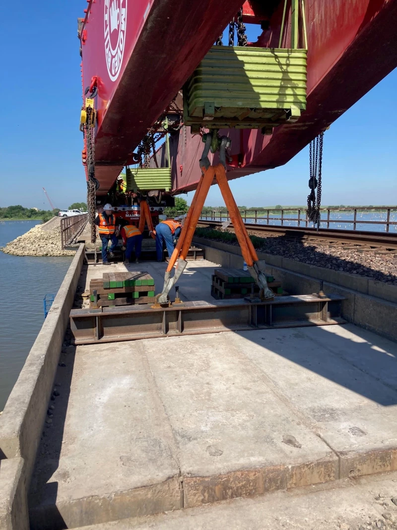 Photo is taken during the removal of the existing 166.3 Bridge over lake Eldorado. This photo was taken under the cantilever While the bridge section was being raised. Project was all conducted along a causeway in the middle of the lake on a work surface 28 feet wide at its widest point.