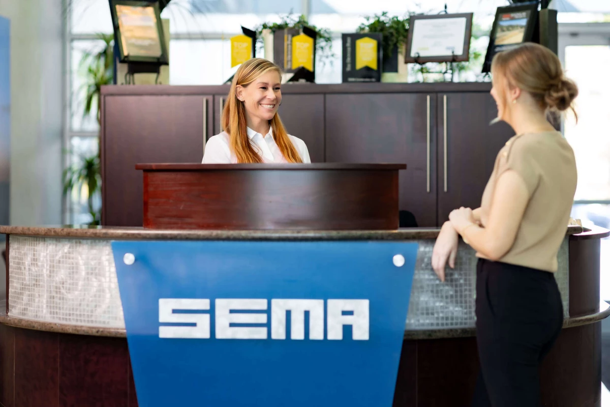 Jessica and Amanda chat at SEMA's front reception desk.
