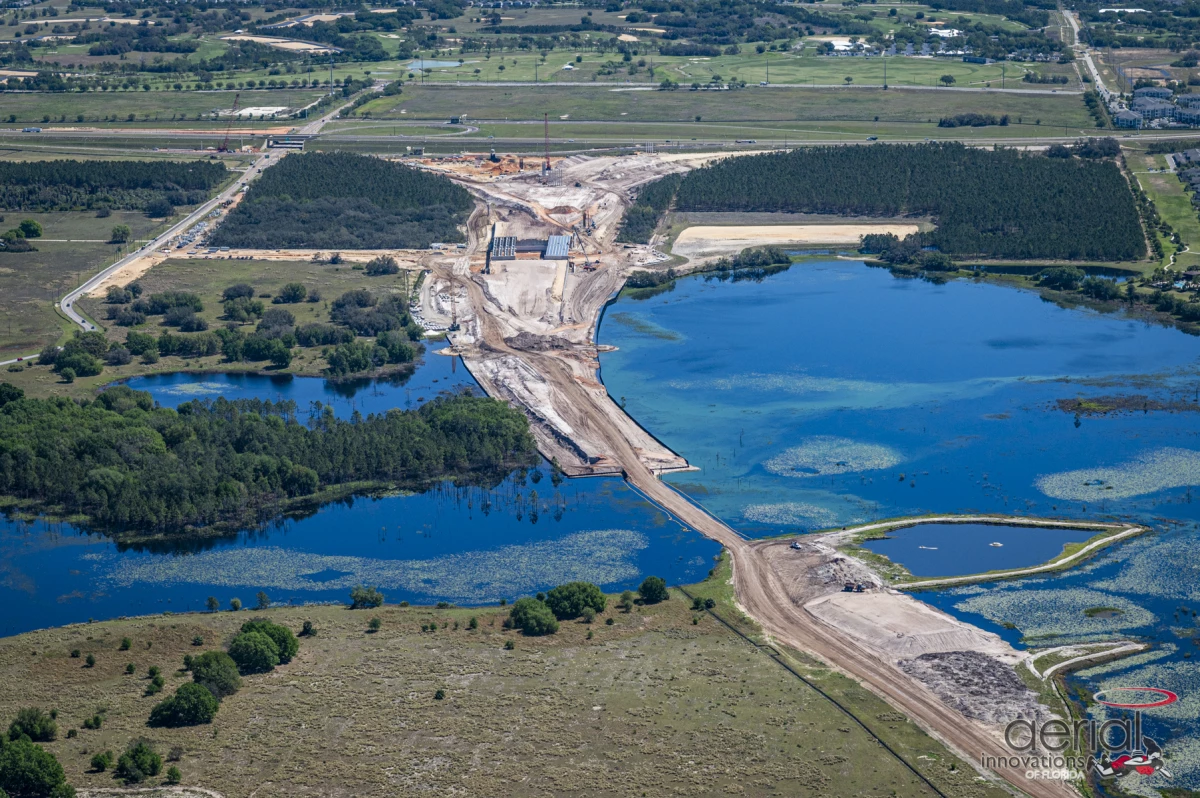 An aerial view of State Road 516 in Clermont, Florida. Image includes a view of a bridge being constructed over water.